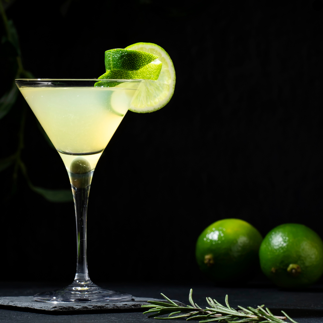 Spooky Holland Road Halloween Sauvignon Blanc and Green Tea Gin Gibbet served in a martini glass with lime wheel garnish on black background.